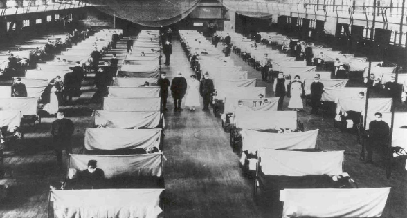 An old black and white photo of hospital beds