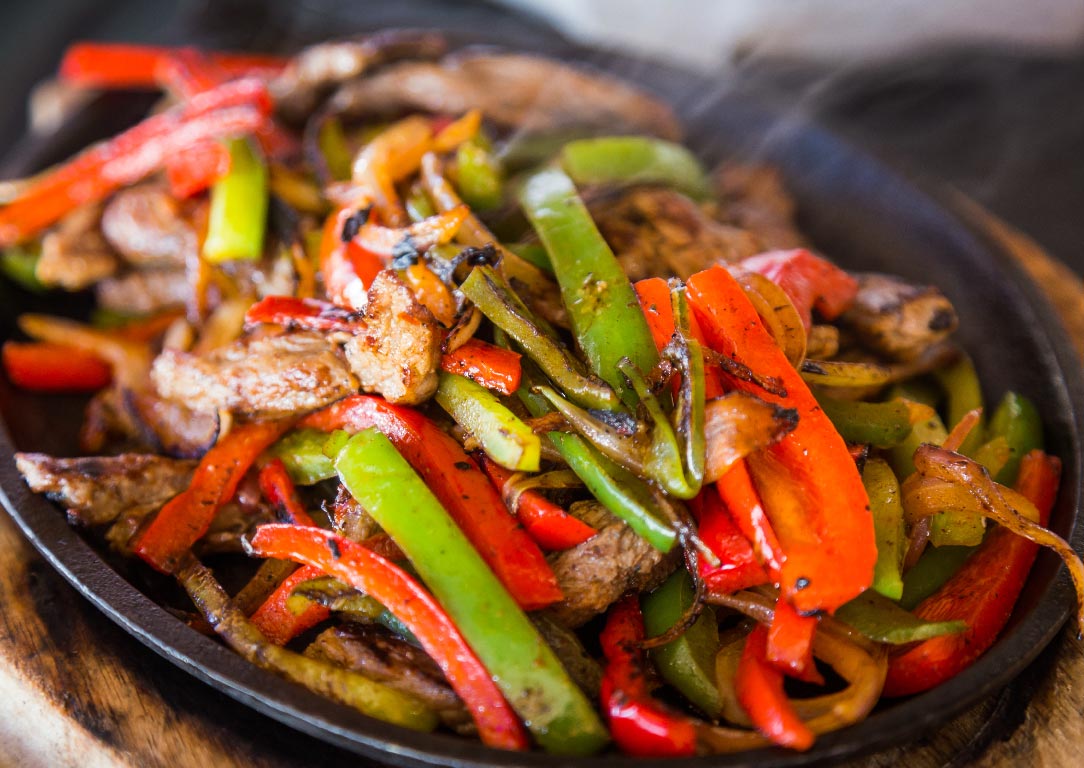 steak fajita with red and green bell peppers and onions