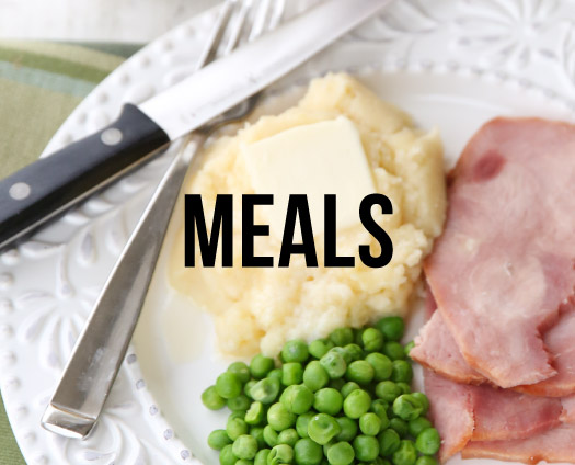 Meals. A plate of mashed potatoes and butter, ham, and peas